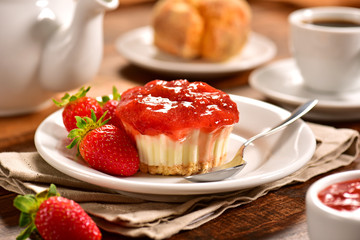 Strawberry individual cheesecake on decorated scene