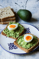 Toast with avocado and egg, bread slice with avocado and egg