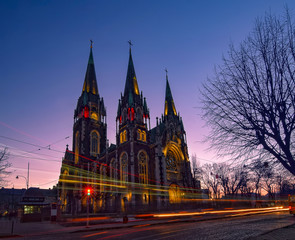 Fototapeta na wymiar Nightscape of ancient gothic church with autotracks