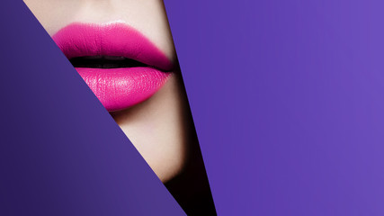 Plump bright pink lips in violet paper frame. Close up beauty photo. Geometry and minimalism. Creative fashion makeup
