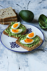Toast with avocado and egg, bread slice with avocado and egg
