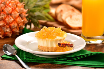 Pineapple individual cheesecake on decorated scene