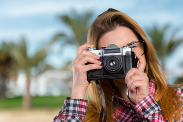 Female photographer holding a vintage camera