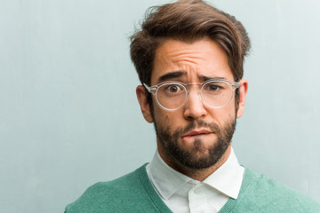 Obraz premium Young handsome entrepreneur man face closeup worried and overwhelmed, forgetful, realize something, expression of shock at having made a mistake
