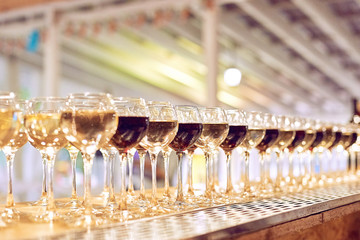 Fototapeta na wymiar wine glasses on corporate party celebration with lights on background