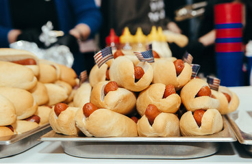many hot dogs on table with small american flags barbecue picnic party