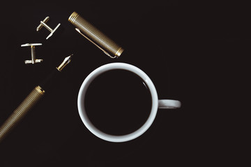 A cup of black coffee with a male fountain pen. Concept fashion business style. 
