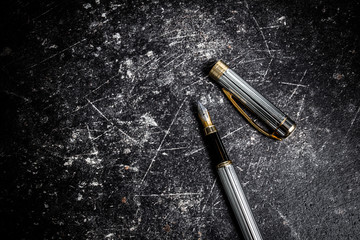 Metal pen on marble background