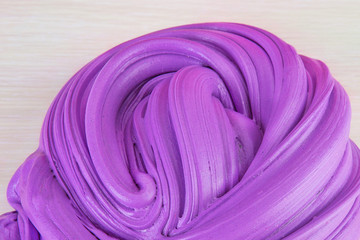 Close up shot of kids slime on light background. Purple slime.Сoncept of children's entertainment, hobbies