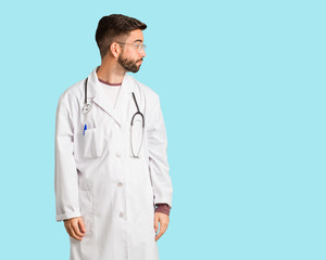 Young doctor man on the side looking to front