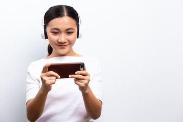 Happy woman playing to the game from smartphone