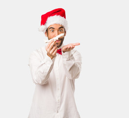 Young man wearing a santa claus hat on Christmas day