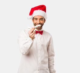 Young man wearing a santa claus hat on Christmas day