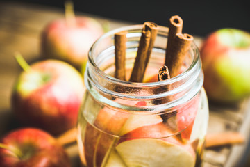 Apple and cinnamon detox drink in jar. Selective focus.