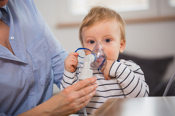 little boy inhaling with nebuliser
