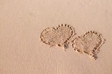 Two heart shapes drawn at the beach