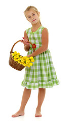Cute little girl with a basket of flowers.