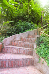 Closeup of handmade  brick stairway with natural background. Vertical view. 