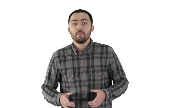 Man in casual walking and talking to the camera on white background.