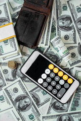 Fototapeta premium dollars and a calculator on a white background. Finance and business concept