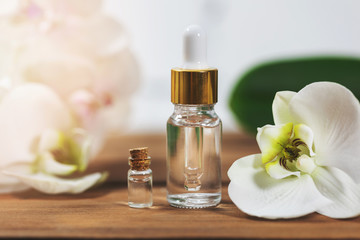 Obraz na płótnie Canvas natural flower essential oil bottles with orchid blossom