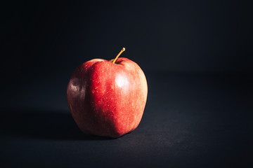 Red ripe Apple on black background.