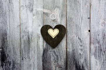 Valentine's day background, two wooden vintage hearts on old wooden table