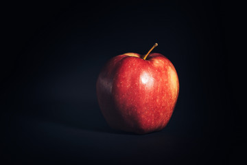 Red ripe Apple on black background.
