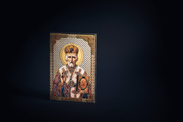 Orthodox icon of St. Nicholas on a black background.