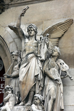 Architectural details of Opera National de Paris: Lyrical Drama Facade sculpture by Perraud. Grand Opera (Garnier Palace) is famous neo-baroque building in Paris, France - UNESCO World Heritage Site.