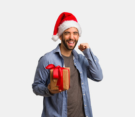 Young man wearing santa hat dancing and having fun