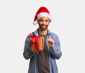 Young man wearing santa hat showing number six