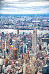 Fototapeta premium Aerial view of Manhattan skyline from the sky on a cloudy day, New York City