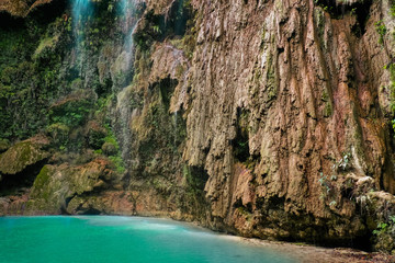 Tumalog waterfall in a mountain gorge in the tropical jungle of the Philippines, Cebu.