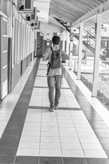 Back view of teenager at school walking outdoor