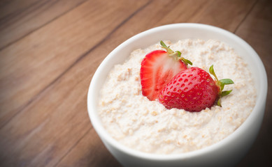 pot with oats, milk and strawberries to use in product packaging