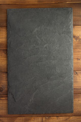 slate stone at wooden background