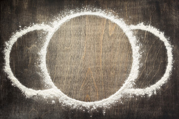 wheat flour powder on wooden background