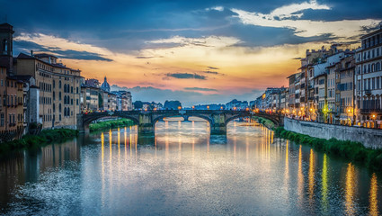 View of the Arno river, evening Florence and the St Trinity Bridge. Florence, Italy.