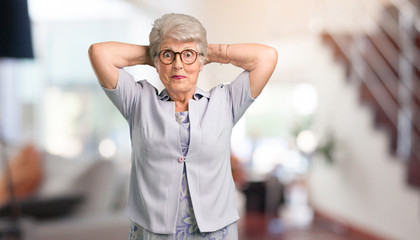Beautiful senior woman crazy and desperate, screaming out of control, funny lunatic expressing...