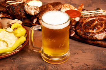 Meat barbecue set on the table. Sausages, pork, mushrooms, beef, sauces, pickles. Beer snacks.