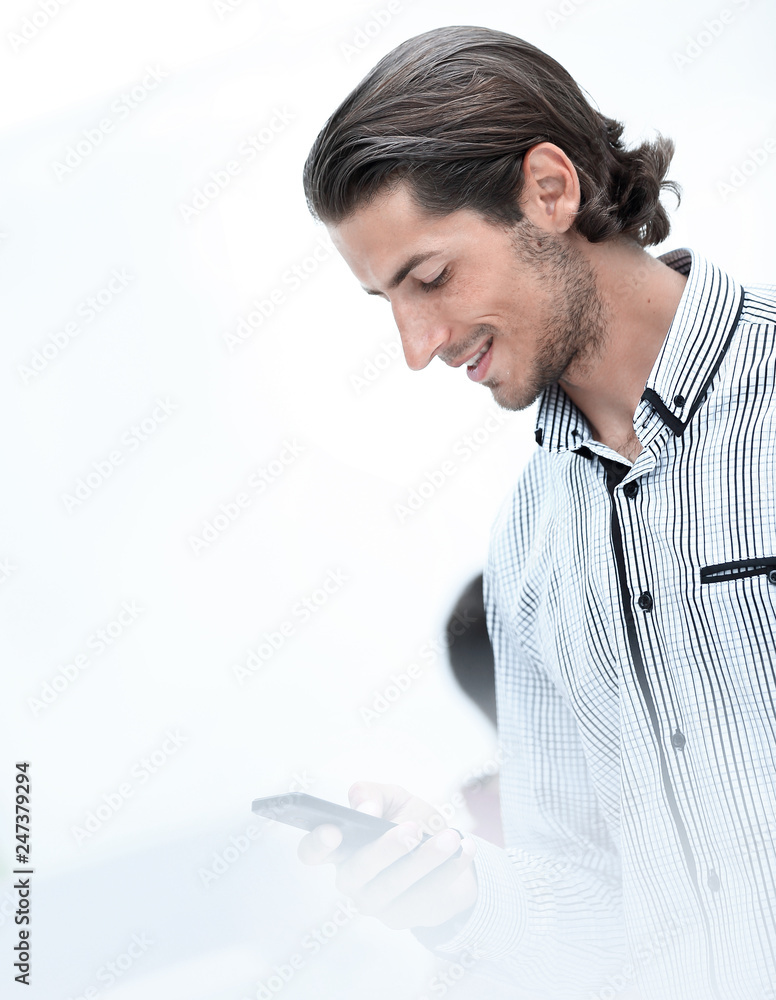 Wall mural Handsome businessman text messaging on mobile phone