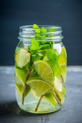 Lime, mint and ginger detox drink in jar. Selective focus.