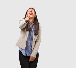 Young business indian woman shouting, laughing and making fun of another, concept of mockery and...