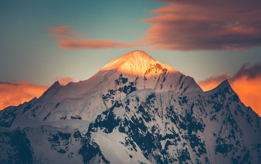 Mountain top colorful sunet, Antarctica. The sunlit snow covered range. Breathtaking polar scenery....