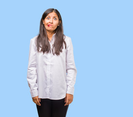 Portrait of a young indian woman worried and overwhelmed, forgetful, realize something, expression...