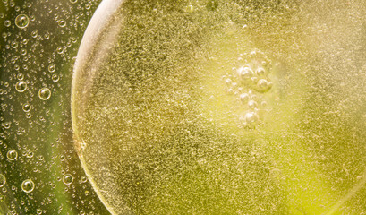 Oil in water bubbles abstract colorful yellow background