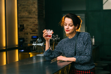 Drunk brunette student woman alone in depressed face expression looking thoughtful in pub or night...