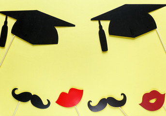Creative background with photobooth props for graduation: hats, diploma, glasses, lips on bright...