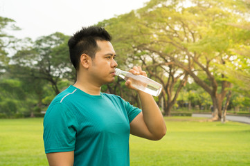 Man rest and drink water after exercise.